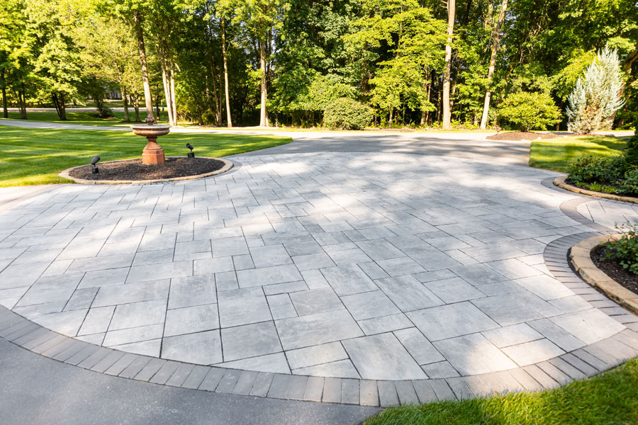 A curved driveway that is made up of concrete tiles